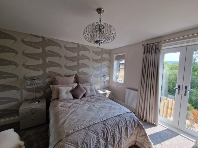 Bedroom with silver leaf-pattern feature wallpaper