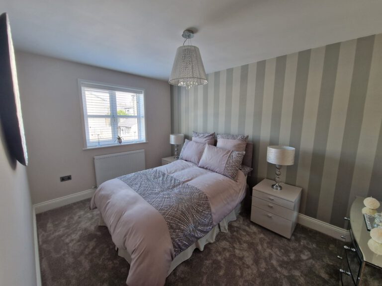 Bedroom with grey striped feature wallpaper
