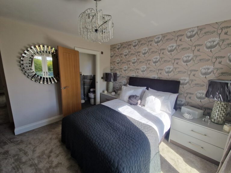 Patterned feature wall behind a bed
