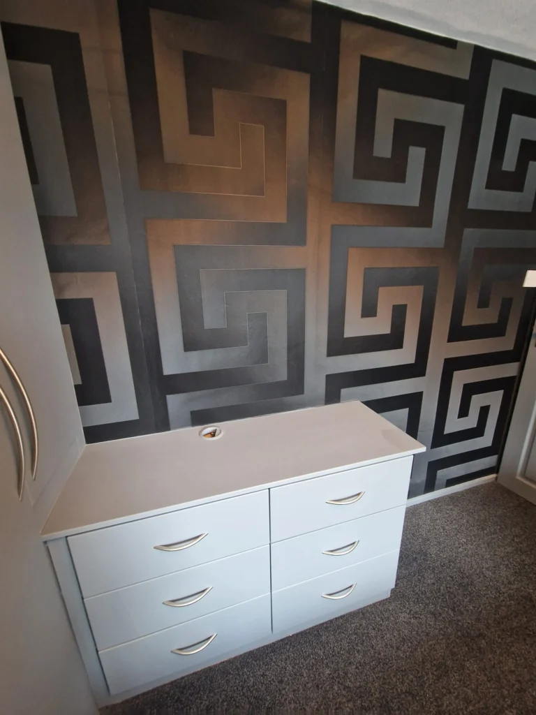 Feature wall with black and gold geometric wallpaper